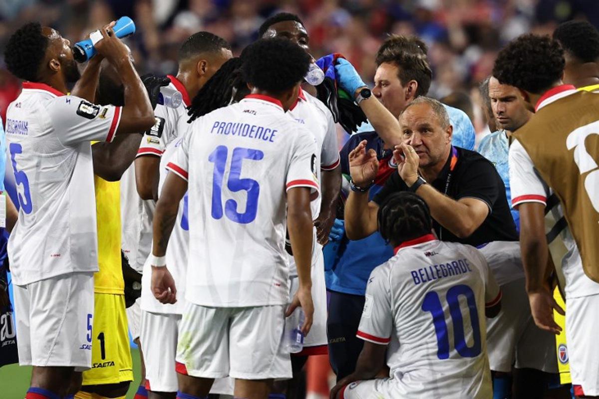 Haiti's French head coach Sebastien Migne talks to his players during the hydration break during the 2026 World Cup Group C football match between Haiti and Scotland at the Boston Stadium in Foxborough on June 13, 2026. FRANCK FIFE / AFP
