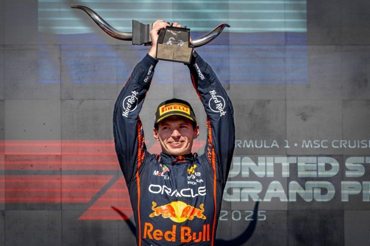 Red Bull Racing's Dutch driver Max Verstappen hoists the trophy on the podium after winning the United States Formula One Grand Prix at the Circuit of the Americas in Austin, Texas, on October 19, 2025. Jim WATSON / AFP