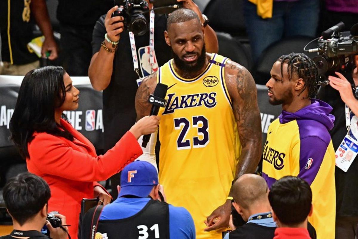 Los Angeles Lakers' US small forward #23 LeBron James (C) and his son, Los Angeles Lakers' US guard #09 Bronny James, speak with the press at the end of the NBA game season opener between the Los Angeles Lakers and the Minnesota Timberwolves at Crypto Arena in Los Angeles on October 22, 2024. LeBron and Bronny are the first father and son to play together in any NBA game. Frederic J. BROWN / AFP