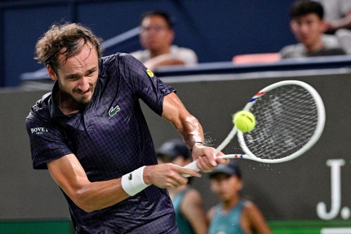 Russia's Daniil Medvedev hits a return to France's Arthur Rinderknech during their men's singles semi-final match at the Shanghai Masters tennis tournament in Shanghai on October 11, 2025. Hector RETAMAL / AFP