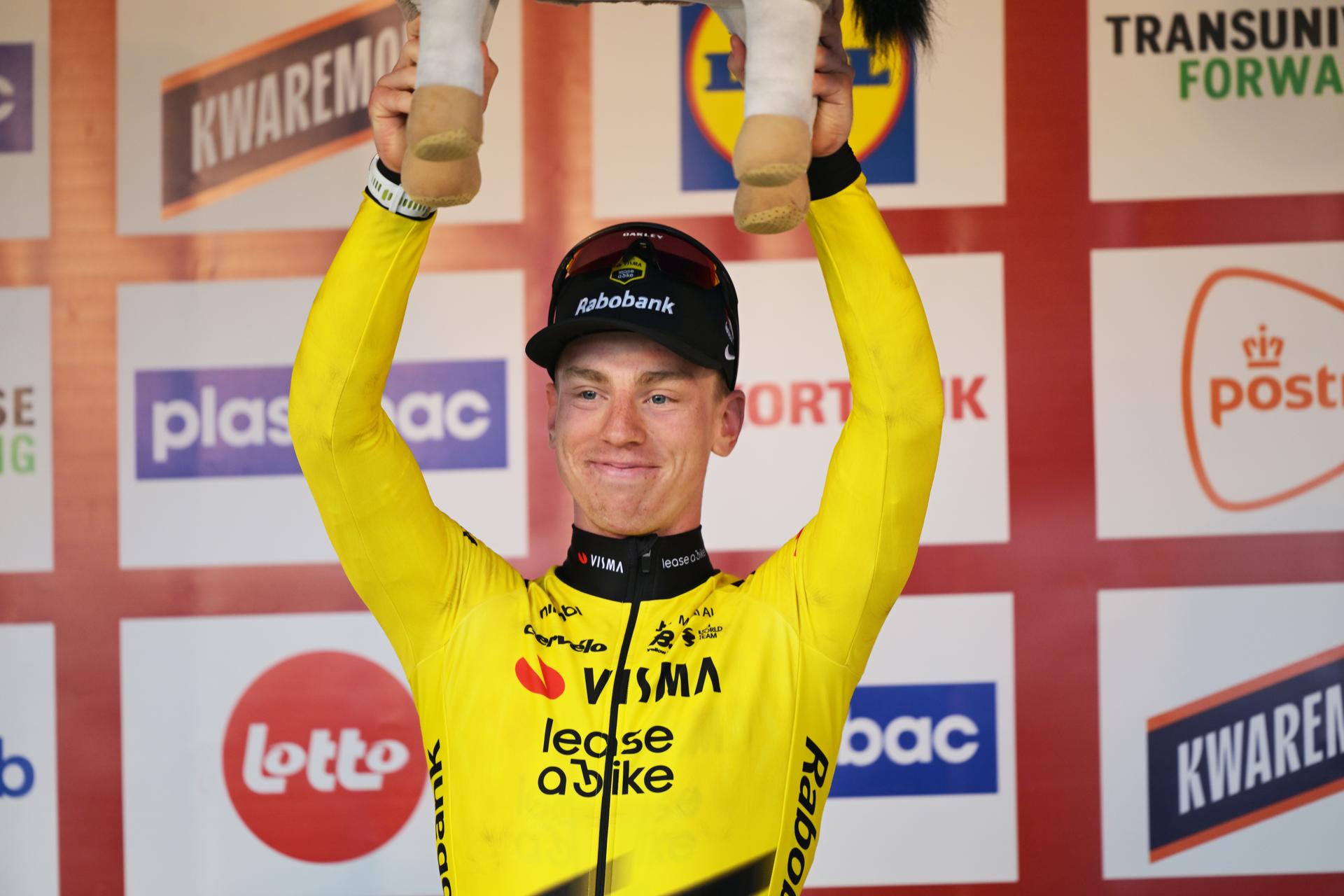 Great Britain's Matthew Brennan of Team Visma-Lease a Bike celebrates on the podium after winning the 78th edition of the men elite race of the Kuurne-Brussels-Kuurne one day cycling race, 195 km from Kuurne to Kuurne via Brussels, Sunday 01 March 2026. BELGA PHOTO DAVID PINTENS