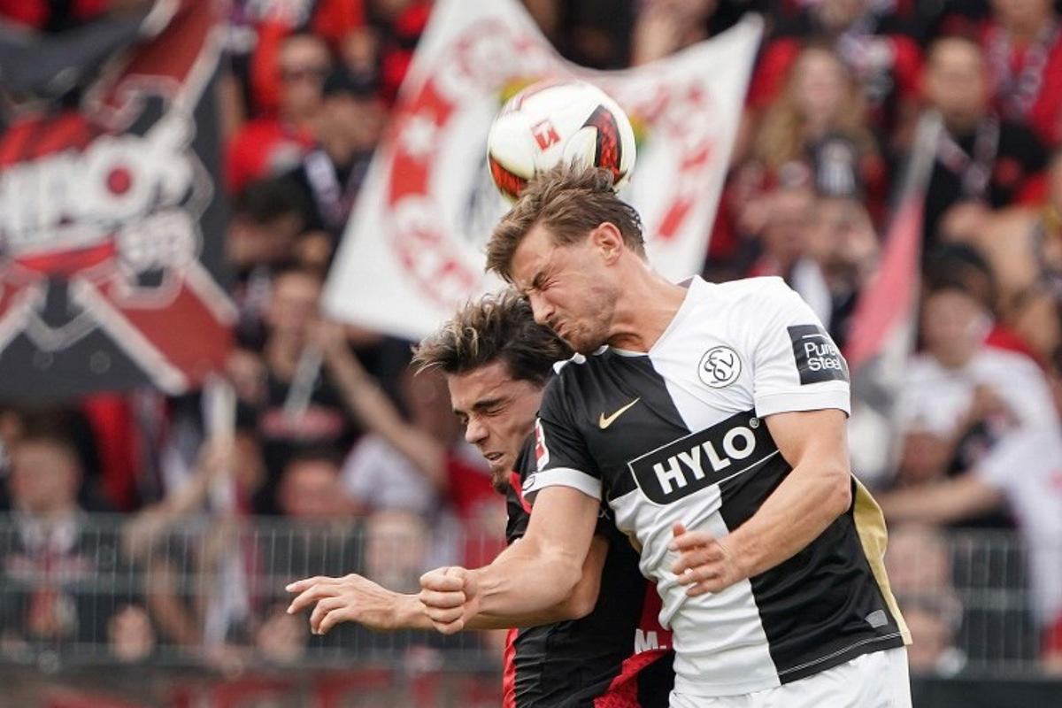 SV Elversberg's Bulgarian forward #25 Lukas Petkov and Bayer Leverkusen's Spanish defender #03 Miguel Gutierrez vie for the ball during the German first division Bundesliga football match between SV Elversberg and Bayer 04 Leverkusen at the Ursapharm Arena in Spiesen-Elversberg, southern Germany on August 29, 2026. Andreas Schlichter / AFP
