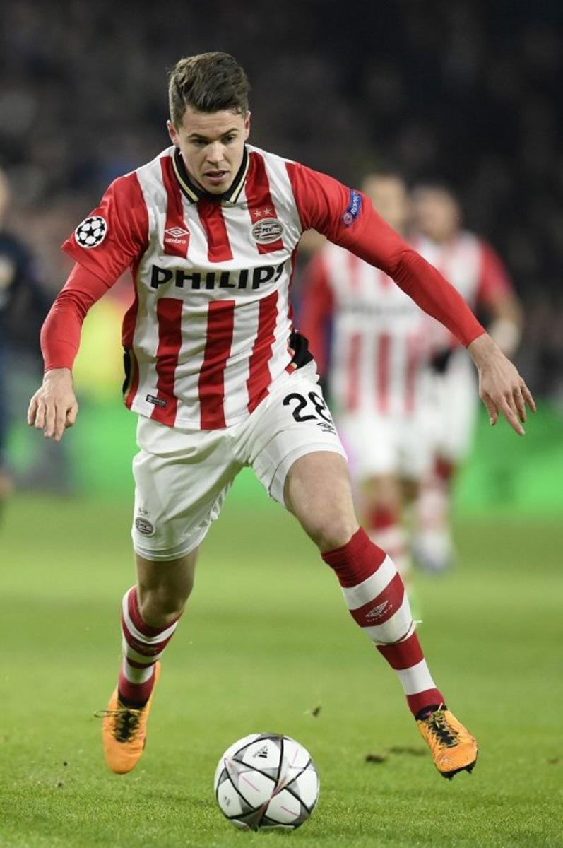 PSV Eindhoven's midfielder Marco van Ginkel runs with the ball during the UEFA Champions League round of 16 first leg football match between PSV Eindhoven and Atletico Madrid at the Philips Stadium in Eindhoven on February 24, 2016. JOHN THYS / AFP