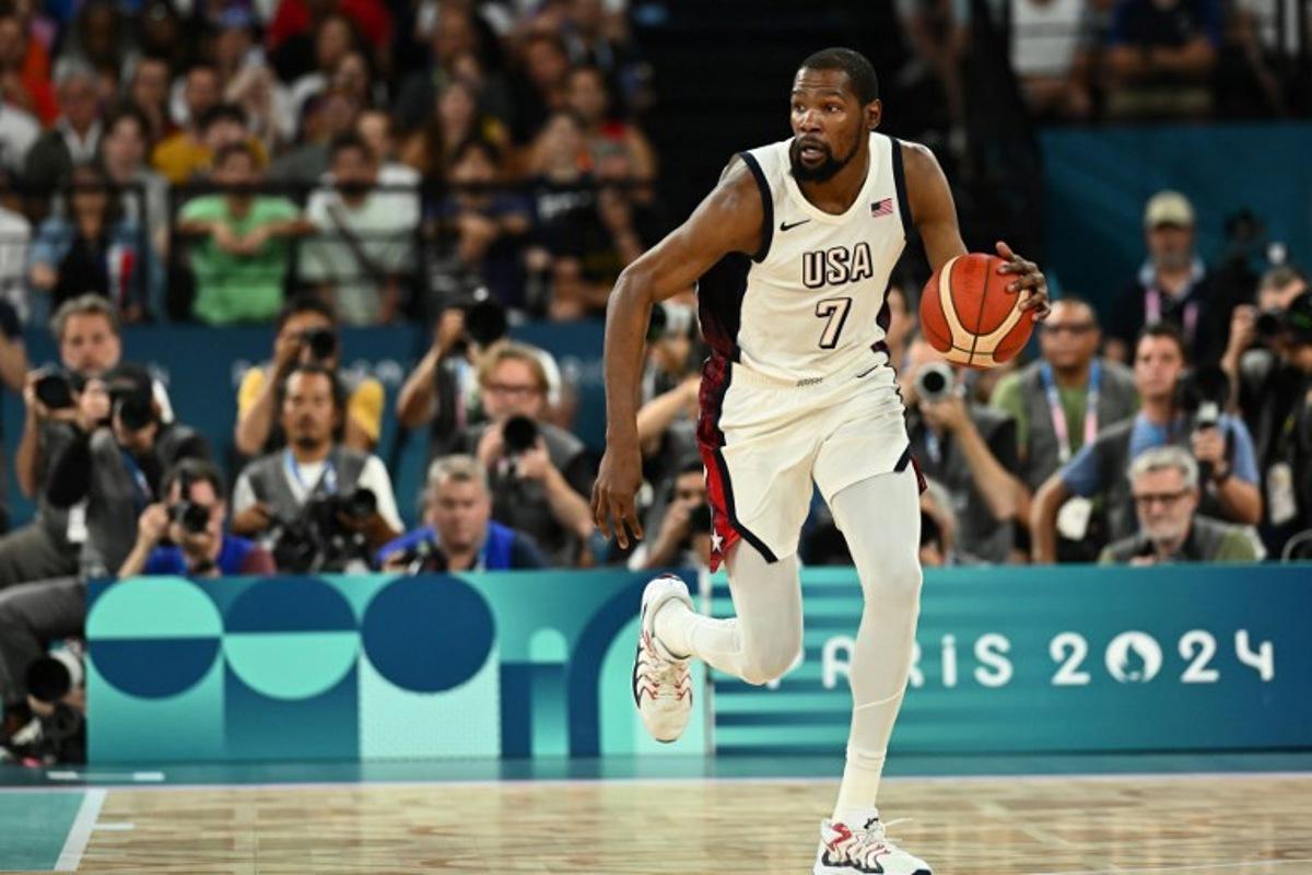 USA's #07 Kevin Durant controls the ball in the men's semifinal basketball match between USA and Serbia during the Paris 2024 Olympic Games at the Bercy Arena in Paris on August 8, 2024. Aris MESSINIS / AFP