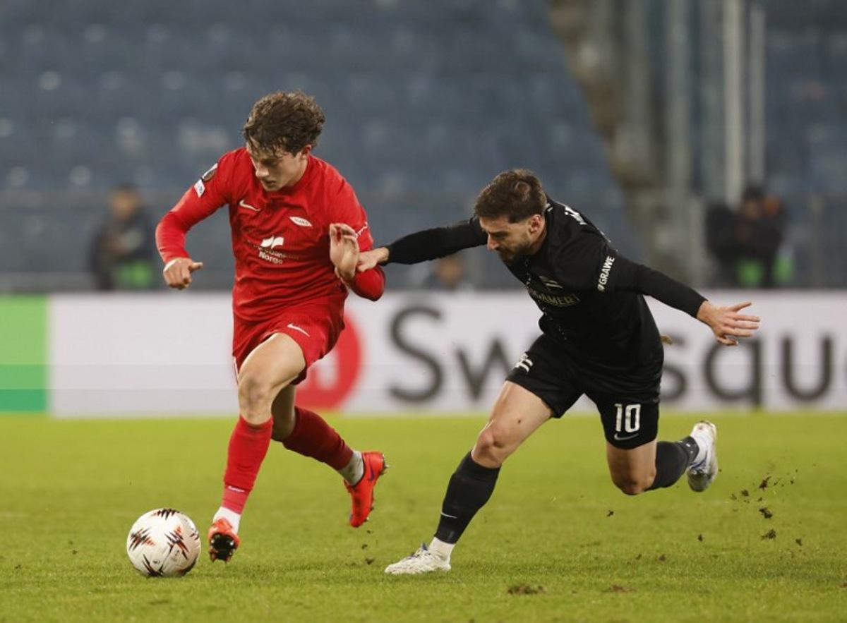 Brann Bergen's Belgian defender #21 Denzel De Roeve (L) and Sturm Graz's Georgian midfielder #10 Otar Kiteishvili vie for the ball during the UEFA Europa League Group first round day 8 football match between Sturm Graz and Brann Bergen in Graz, on January 29, 2026. ERWIN SCHERIAU / APA / AFP