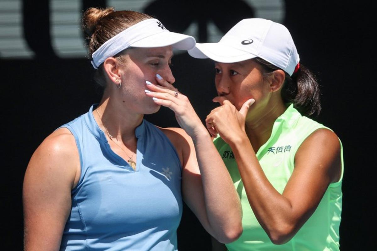 Belgium's Elise Mertens (L) talks to partner China's Zhang Shuai during their women's doubles final match against Kazakhstan's Anna Danilina and Serbia's Aleksandra Krunic on day fourteen of the Australian Open tennis tournament in Melbourne on January 31, 2026. DAVID GRAY / AFP