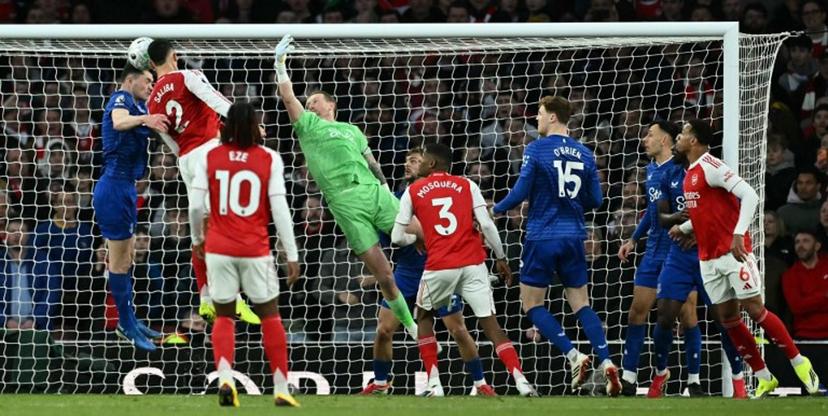 Everton's English defender #05 Michael Keane (L) defends a header by Arsenal's French defender #02 William Saliba during the English Premier League football match between Arsenal and Everton at the Emirates Stadium in London on March 14, 2026. Ben STANSALL / AFP