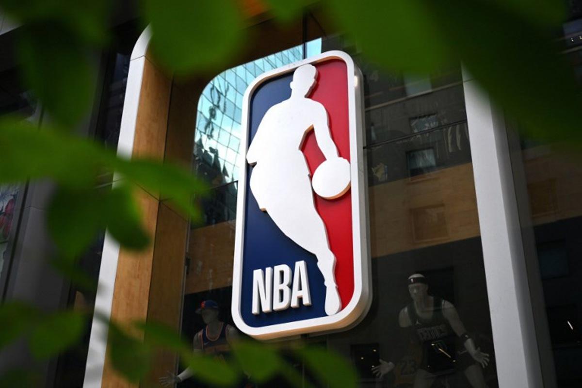 The NBA logo is seen outside an NBA fan store in New York on July 8, 2024. ANGELA WEISS / AFP