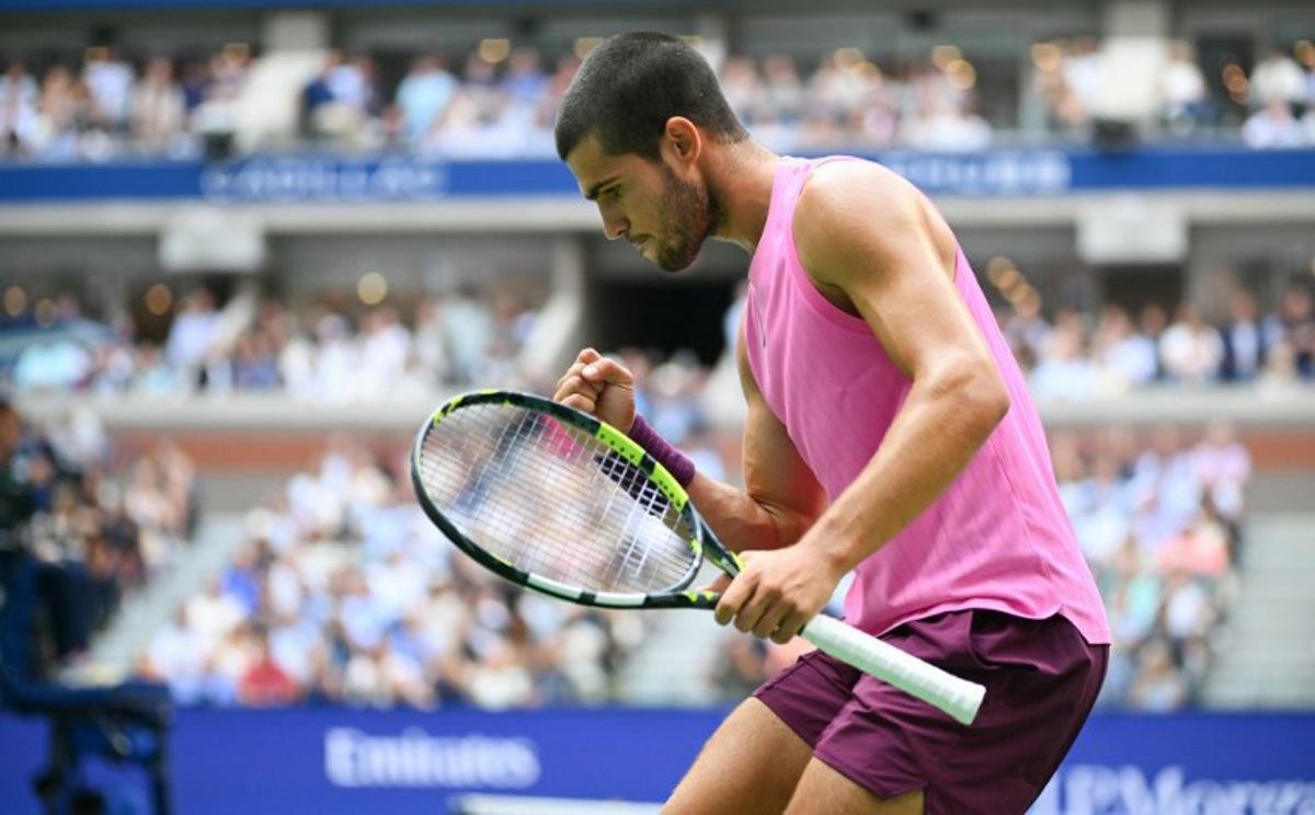 Spain's Carlos Alcaraz reacts to a point to Serbia's Novak Djokovic during their men's singles semifinal tennis match on day thirteen of the US Open tennis tournament at the USTA Billie Jean King National Tennis Center in New York City, on September 5, 2025. ANGELA WEISS / AFP