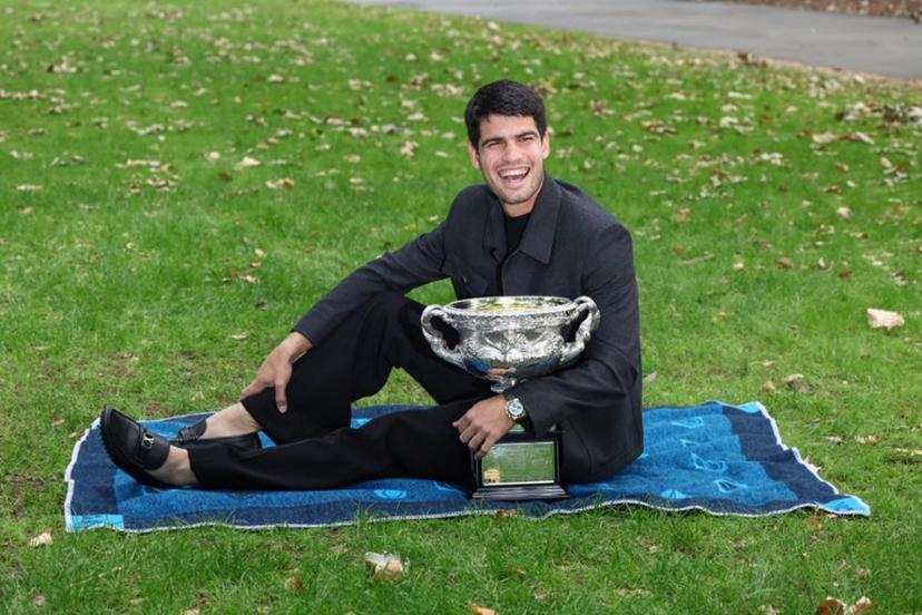 Spain's Carlos Alcaraz poses with the Norman Brookes Challenge Cup at the Royal Exhibition Building following his victory against Serbia's Novak Djokovic in the men's singles final match of the Australian Open tennis tournament in Melbourne on February 2, 2026. David GRAY / AFP