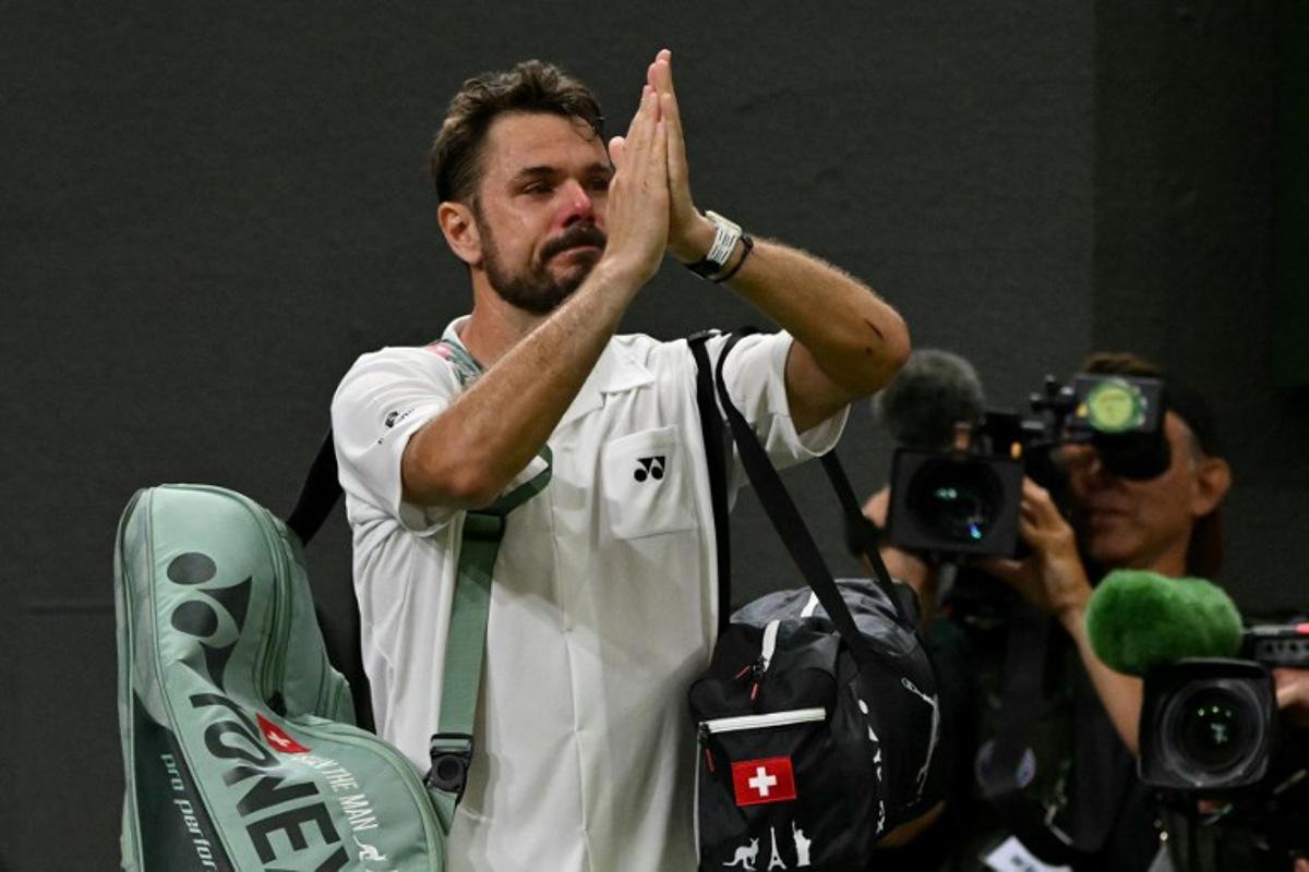 Switzerland's Stan Wawrinka gestures to the crowd as he leaves following his defeat to Italy's Matteo Berrettini during their men's singles first round tennis match on the second day of the 2026 Wimbledon Championships at The All England Lawn Tennis and Croquet Club in Wimbledon, southwest London, on June 30, 2026. Glyn KIRK / AFP