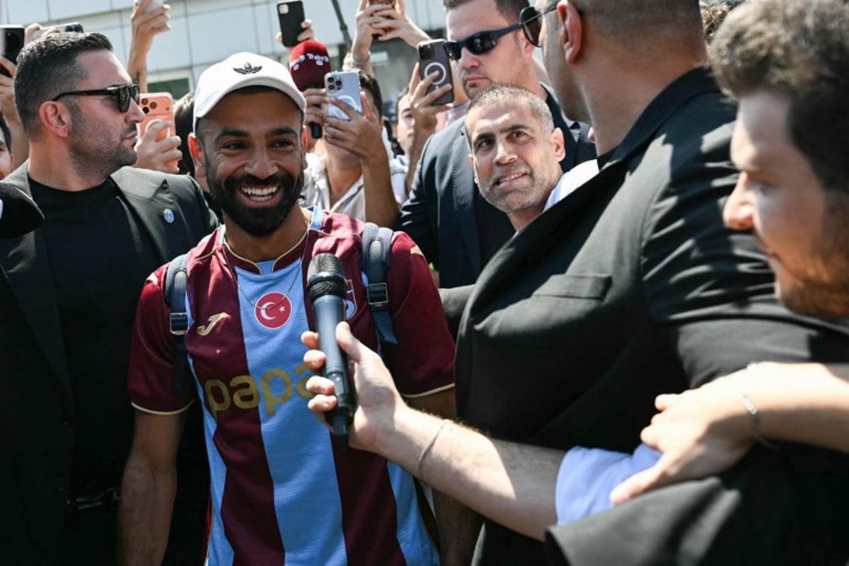 Egyptian forward Mohamed Salah reacts as he arrives at Istanbul Ataturk Airport to complete his transfer to Turkish football club Trabzonspor in Istanbul on August 5, 2026. Ozan KOSE / AFP