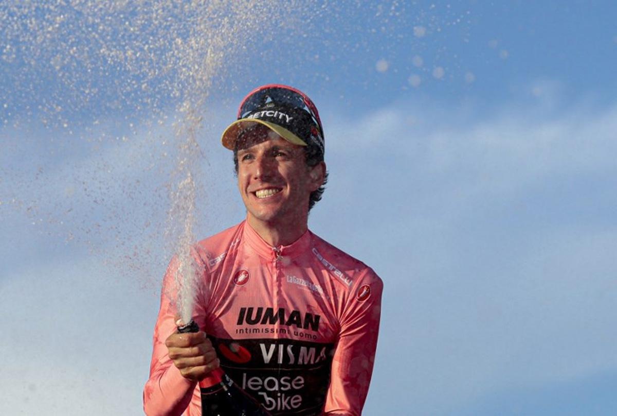 Team Visma-Lease a Bike's British rider Simon Yates wearing the pink jersey of overall leader (Maglia Rosa) celebrates on the podium after the 21st and last stage and winning the 108th Giro d'Italia cycling race of 143kms from Rome to Rome on June 1, 2025. Luca Bettini / AFP