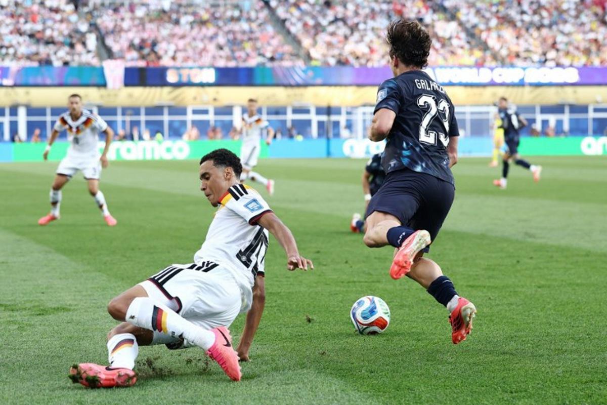 Germany's midfielder #10 Jamal Musiala (L) fouls Paraguay's midfielder #23 Matias Galarza during the 2026 World Cup round of 32 football match between Germany and Paraguay at the Boston Stadium in Foxborough on June 29, 2026. CHARLY TRIBALLEAU / AFP