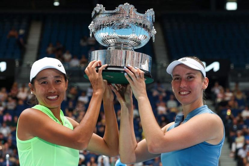 China's Zhang Shuai (L) and partner Belgium's Elise Mertens pose with the winners' trophy after their victory in their women's doubles final match against Kazakhstan's Anna Danilina and Serbia's Aleksandra Krunic on day fourteen of the Australian Open tennis tournament in Melbourne on January 31, 2026. DAVID GRAY / AFP