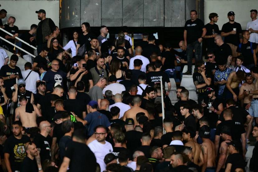 Juventus' supporters leave the stadium after a suspension of the Italian Serie A football match betweem Torino and Juventus FC at the Olympic Stadium Grande Torino in Turin on May 24, 2026. MARCO BERTORELLO / AFP