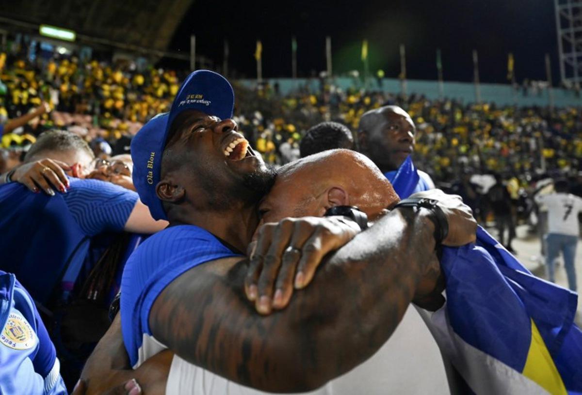 Curaçao fans celebrate World Cup 2026 qualification after a 0-0 draw with Jamaica at the National Stadium in Kingston, Jamaica on November 18, 2025. The tiny Caribbean nation of Curacao became the smallest country ever to qualify for the World Cup on November 18 as Haiti booked their return to the tournament for the first time in 52 years along with Panama. A nerve-shredding finale to the CONCACAF qualifying campaign saw Curacao -- with a population of just 156,000 -- squeeze into next year's finals in the United States, Canada and Mexico with a 0-0 draw against Jamaica in Kingston. Ricardo MAKYN / AFP