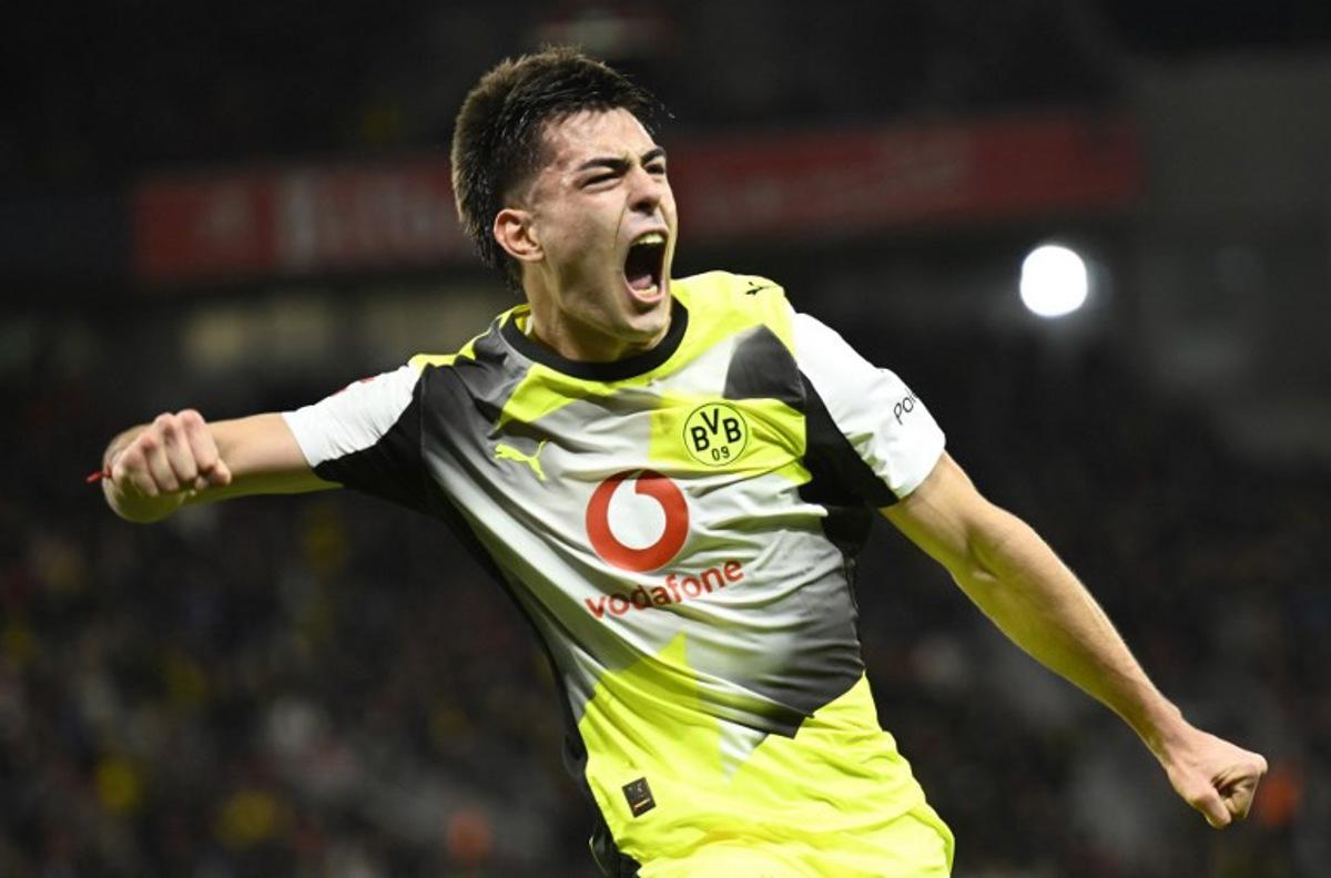 Dortmund's Argentinian defender #28 Aaron Anselmino celebrates his 0-1 during the German first division Bundesliga football match between Bayer 04 Leverkusen and Borussia Dortmund in Leverkusen, western Germany, on November 29, 2025. INA FASSBENDER / AFP