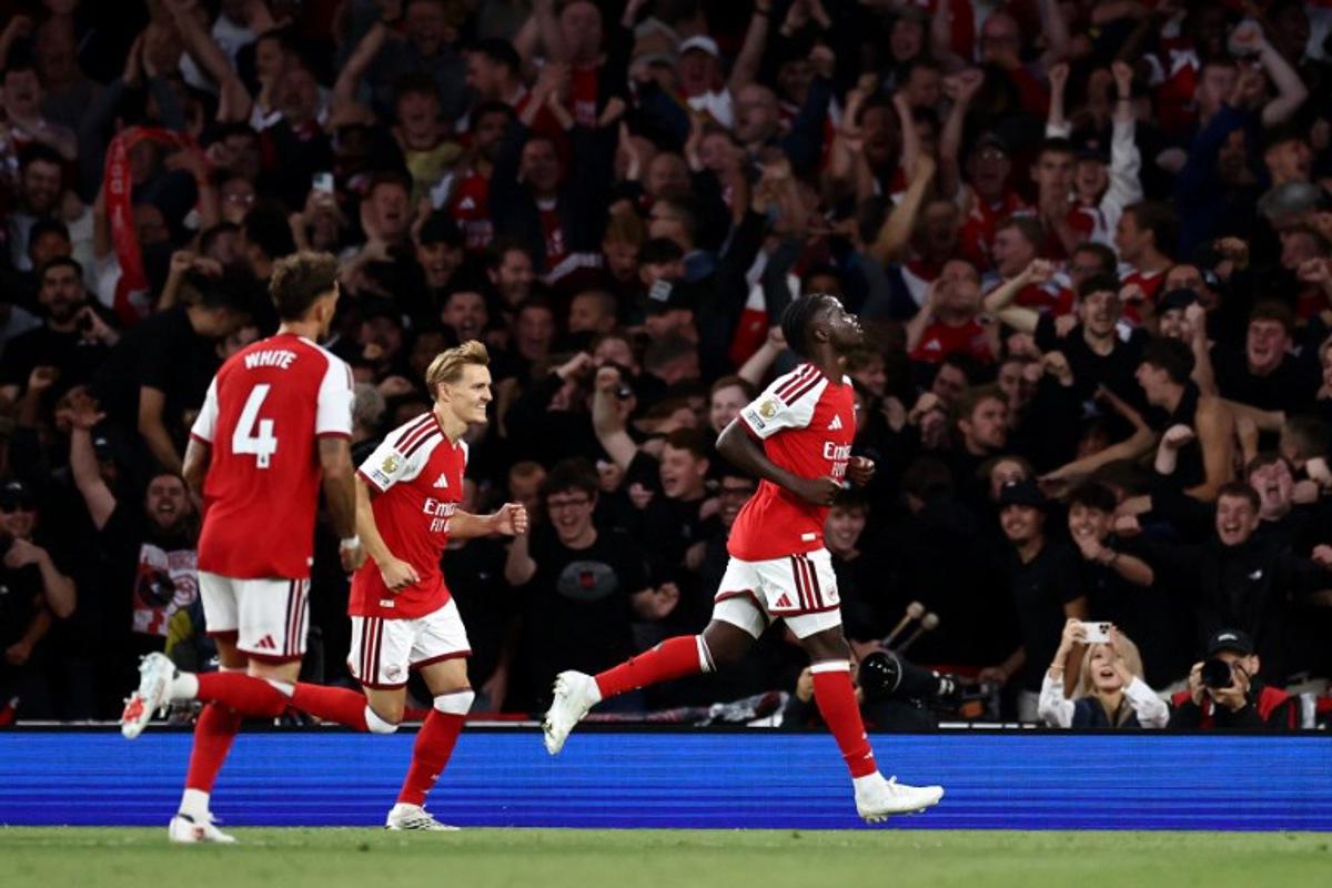 Arsenal's English midfielder #07 Bukayo Saka (R) celebrates scoring the team's second goal during the English Premier League football match between Arsenal and Coventry City at the Emirates Stadium in London on August 21, 2026. Henry NICHOLLS / AFP
