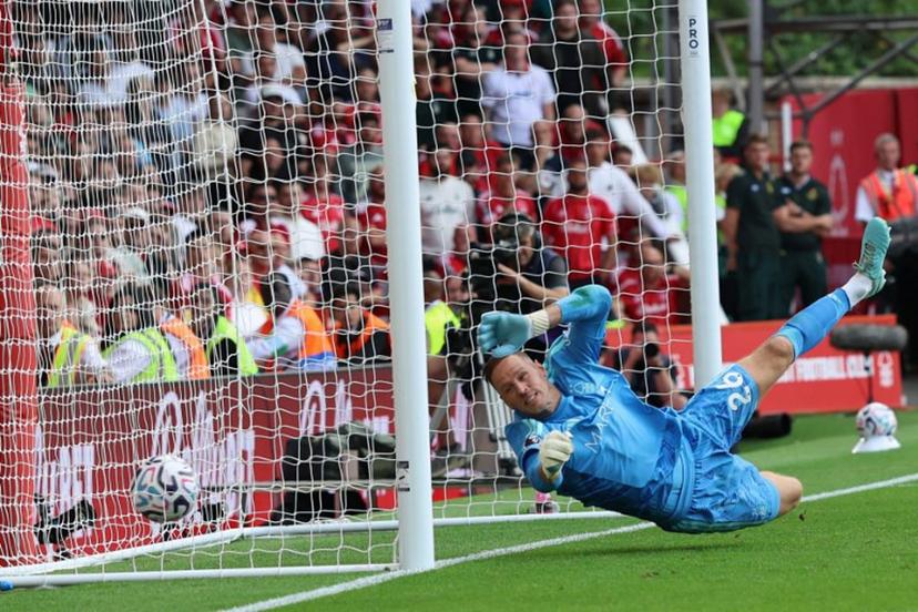 Nottingham Forest's Belgian goalkeeper #26 Matz Sels fails to stop a shot from Leeds United's German midfielder #18 Anton Stach as Leeds score a late winner during the English Premier League football match between Nottingham Forest and Leeds United at The City Ground in Nottingham, central England, on August 22, 2026. Darren Staples / AFP