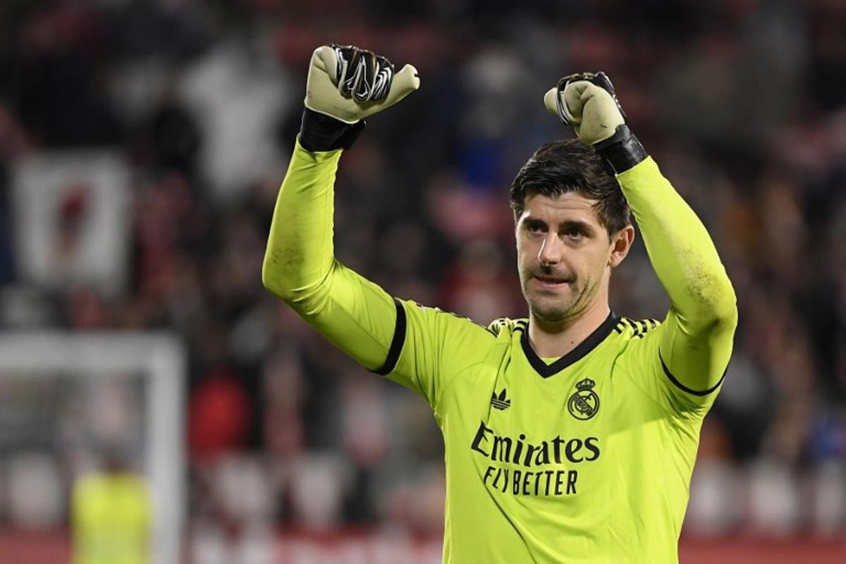 Real Madrid's Belgian goalkeeper #01 Thibaut Courtois celebrates at the end of the Spanish league football match between Girona FC and Real Madrid CF at the Montilivi stadium in Girona on December 7, 2024. Josep LAGO / AFP