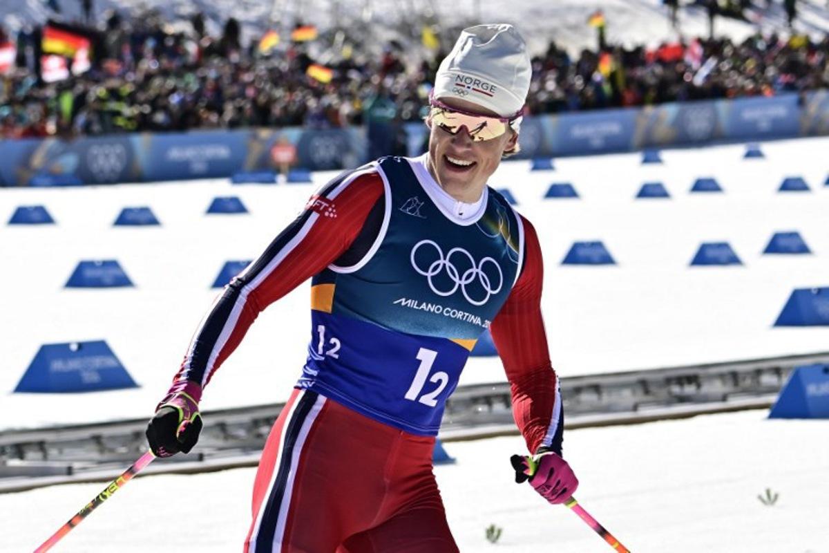 Norway's Johannes Hoesflot Klaebo celebrates after crossing the finish line for Norway to win gold during the men's team cross country free sprint final event of the Milano Cortina 2026 Winter Olympic Games at Tesero Cross-Country Skiing Stadium in Lago di Tesero (Val di Fiemme), on February 18, 2026. Tobias SCHWARZ / AFP