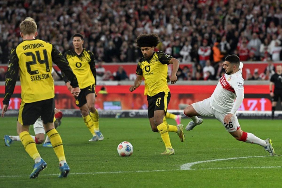Stuttgart's German forward #26 Deniz Undav (R) and Dortmund's German forward #27 Karim Adeyemi vie for the ball during the German first division Bundesliga football match between VfB Stuttgart and BVB Borussia Dortmund in Stuttgart, southern Germany, on April 4, 2026. THOMAS KIENZLE / AFP