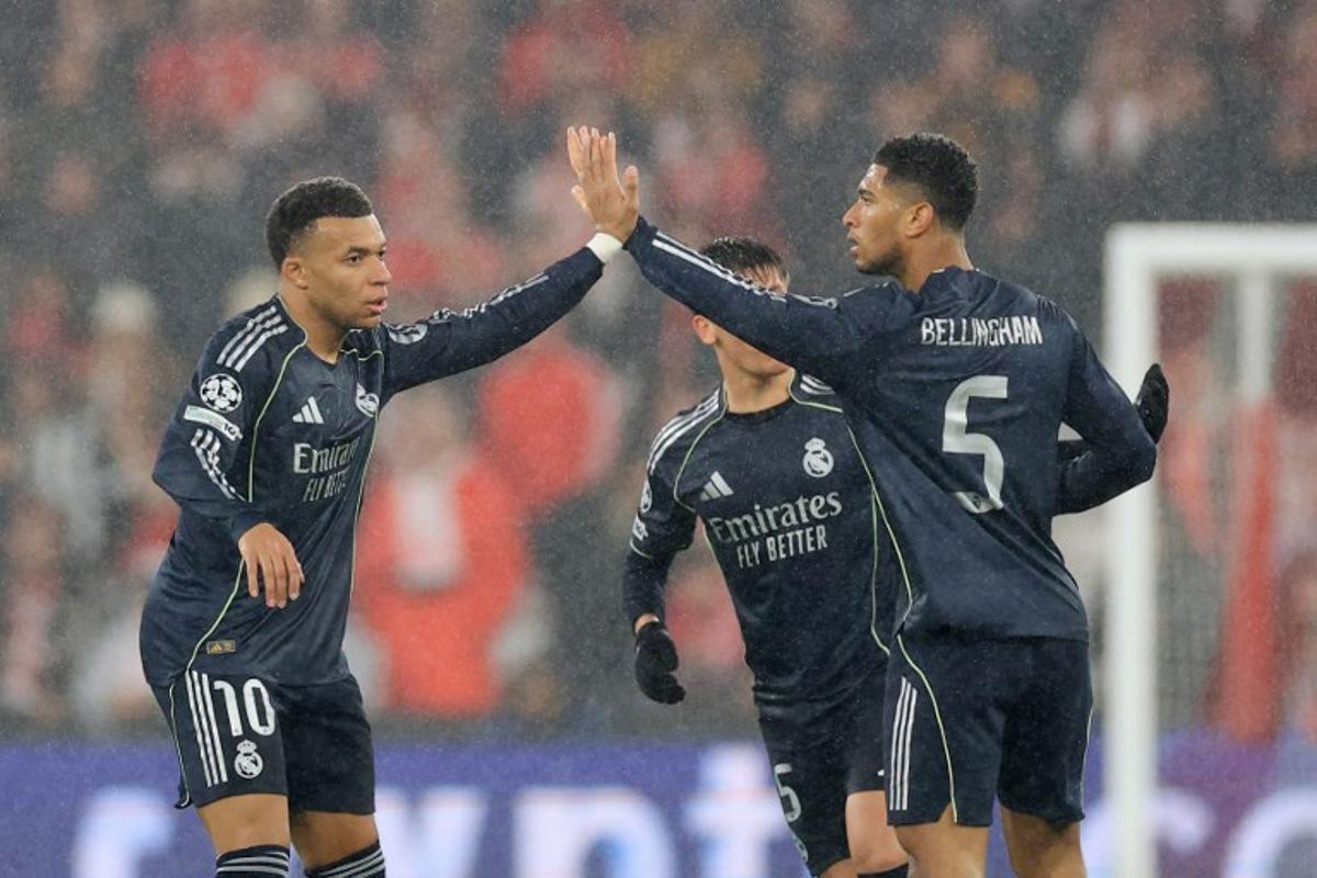 Real Madrid's French forward #10 Kylian Mbappe (L) celebrates after scoring his team's second goal with teammate English midfielder #05 Jude Bellingham (R) during the UEFA Champions League league phase day 8 football match between SL Benfica and Real Madrid CF at Estadio da Luz in Lisbon on January 28, 2026. PATRICIA DE MELO MOREIRA / AFP