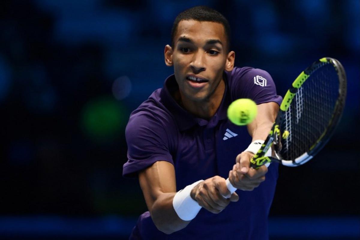 Canada's Felix Auger Aliassime plays a backhand return against Germany's Alexander Zverev during their men's single tennis match at the ATP Finals tennis tournament, in Turin, on November 14, 2025. MARCO BERTORELLO / AFP