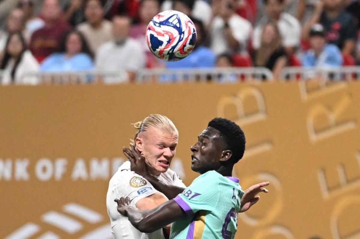 Manchester City's Norwegian striker #09 Erling Haaland and Al Ain's Senegalese defender #56 Amadu Niang fight for the ball during the FIFA Club World Cup 2025 Group G football match between England's Manchester City and UAE's Al Ain FC at the Mercedes-Benz stadium in Atlanta on June 22, 2025. PATRICIA DE MELO MOREIRA / AFP