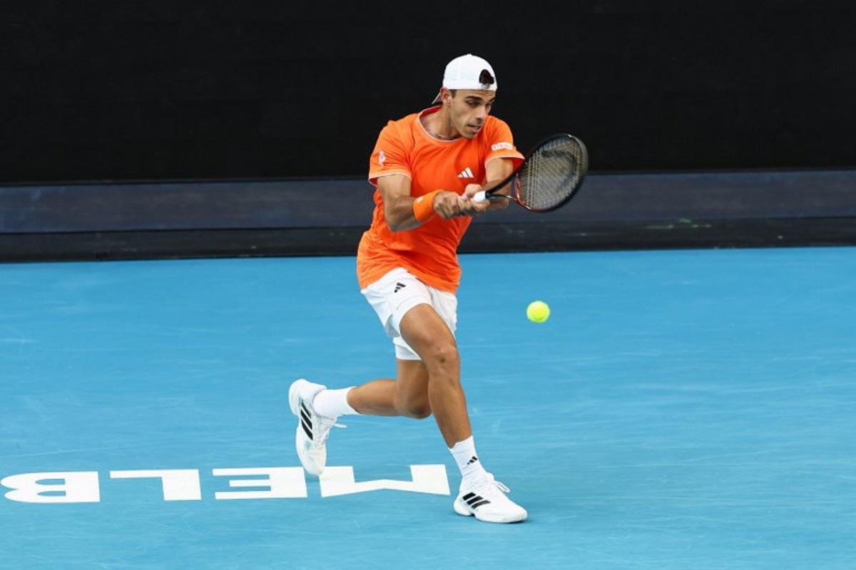 Argentina's Francisco Cerundolo hits a shot against Germany's Alexander Zverev during their men's singles match on day eight of the Australian Open tennis tournament in Melbourne on January 25, 2026. IZHAR KHAN / AFP