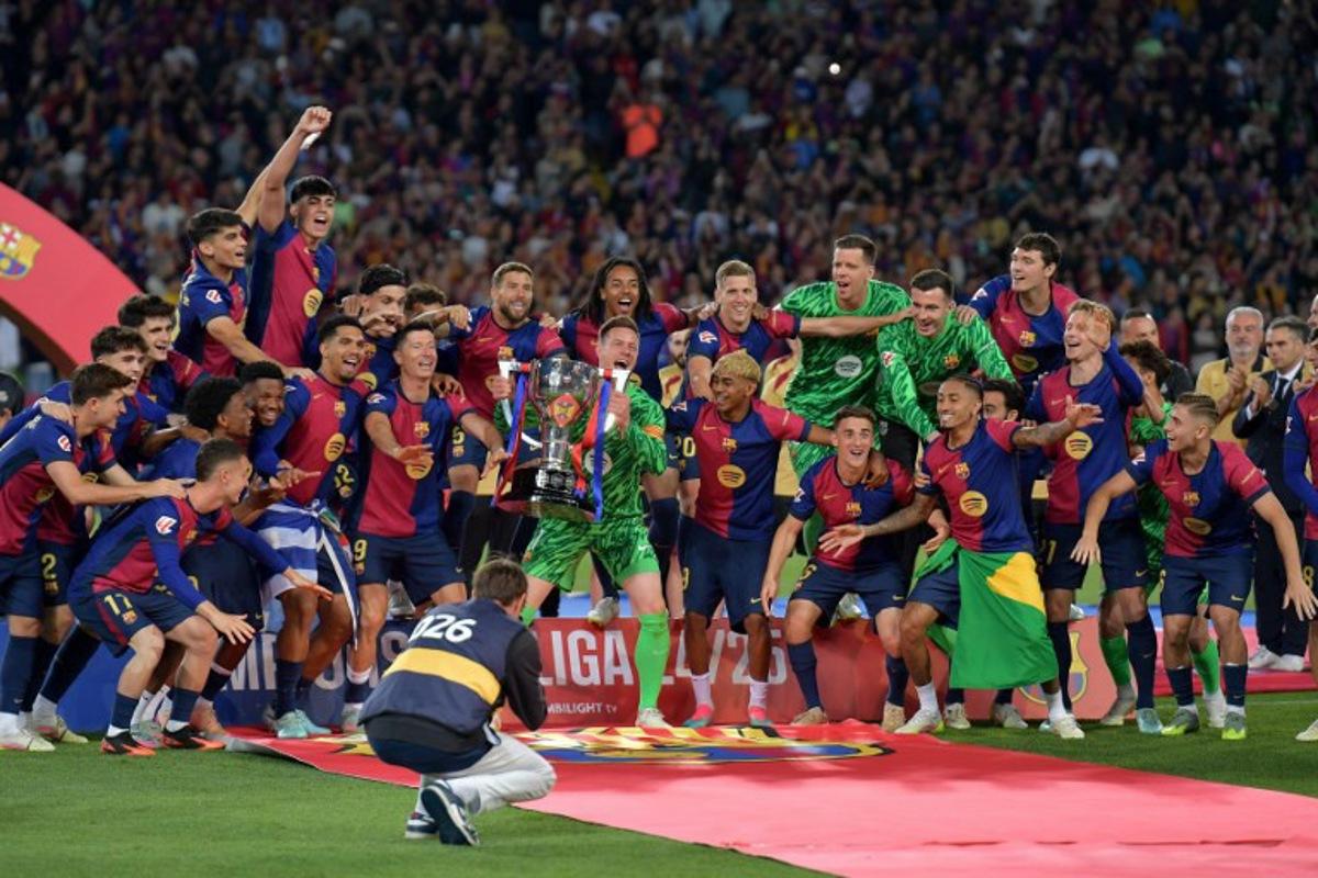 Barcelona's players celebrate their 28th Liga title after the Spanish league football match between FC Barcelona and Villarreal CF at Estadi Olimpic Lluis Companys in Barcelona on May 18, 2025. MANAURE QUINTERO / AFP