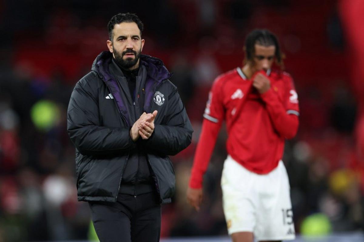 Manchester United's Portuguese head coach Ruben Amorim applauds fans on the pitch after the English Premier League football match between Manchester United and Everton at Old Trafford in Manchester, north west England, on November 24, 2025. Everton won the game 1-0. Darren Staples / AFP