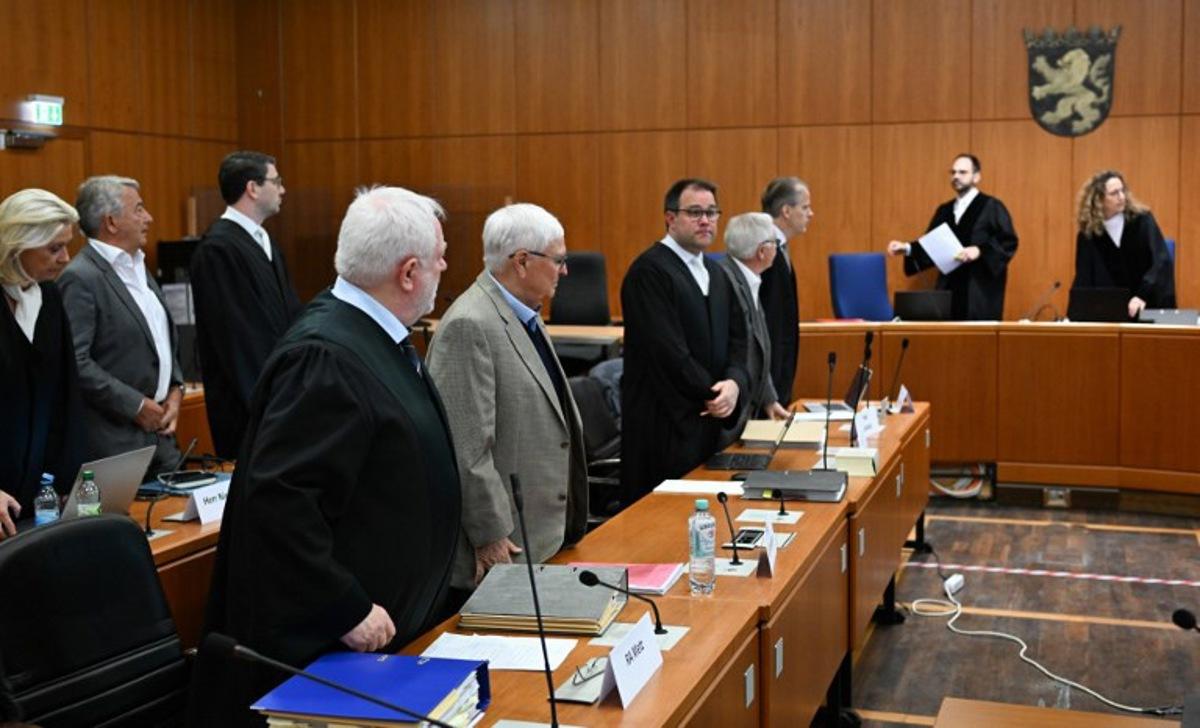 Former Presidents of Germany's Football Federation (Deutscher Fussball Bund, DFB) Theo Zwanziger (1st row, 2nd L) and Wolfgang Niersbach (2nd row, 2nd L) are seen next to their lawyers as they wait for the continuation of a trial for tax fraud amounting to 13.7 million euros for the benefit of the DFB in connection with the 2006 World Cup hosted by Germany, in Frankfurt am Main, western Germany, April 15, 2024. Arne Dedert / POOL / AFP