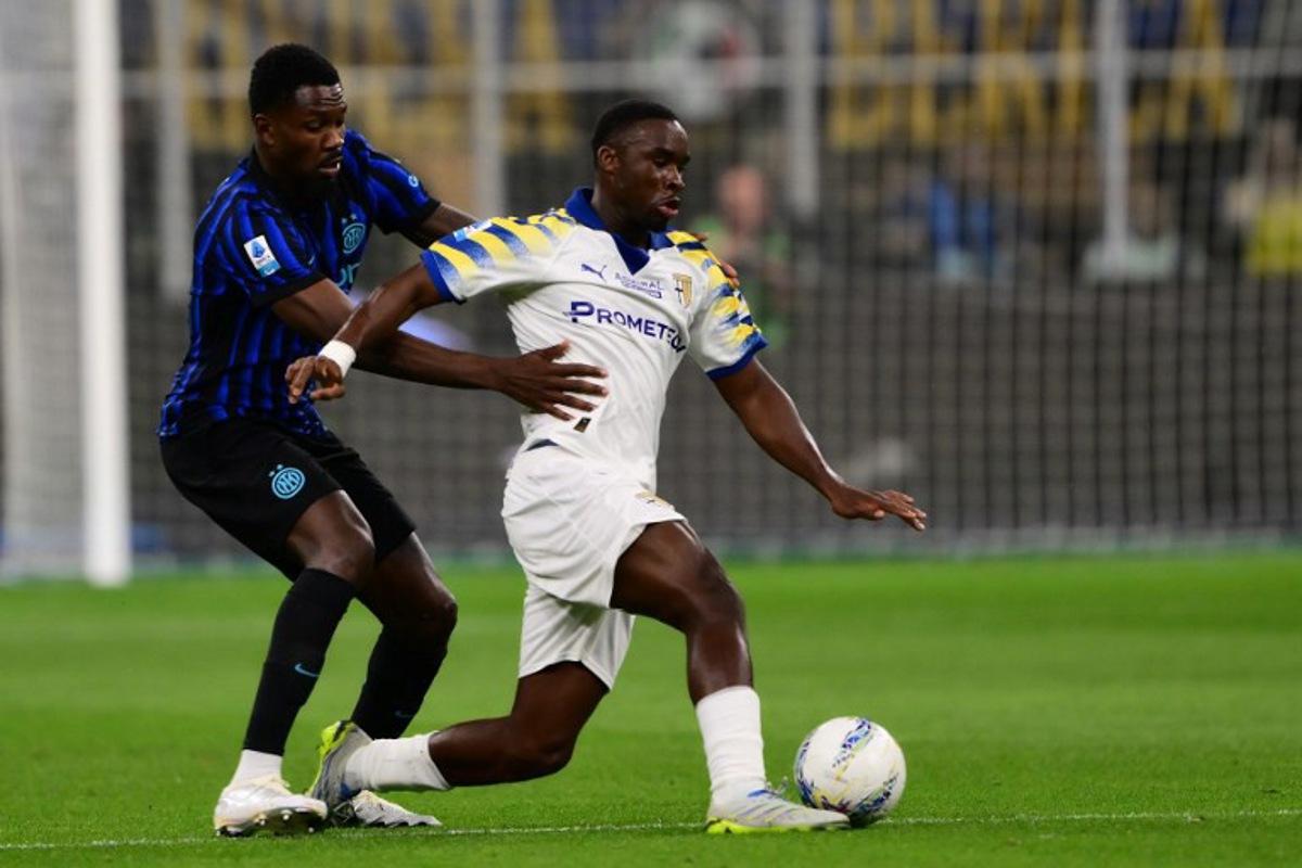 Inter Milan's French forward #9 Marcus Thuram (L) fights for the ball with Parma's Belgian midfielder #16 Mandela Keita during the Italian Serie A football match between Inter Milan and Parma at San Siro stadium in Milan, on May 3, 2026. Marco BERTORELLO / AFP
