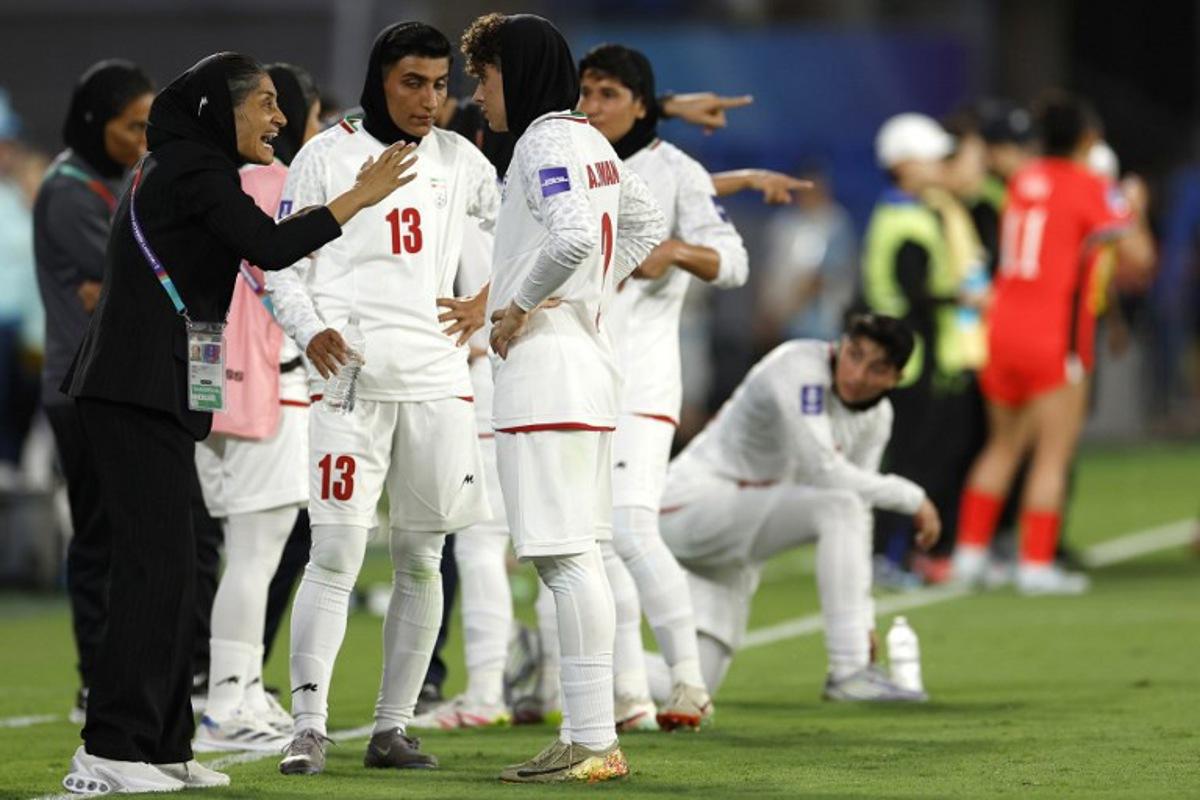 Iran's Head Coach Marziyeh Jafari Baravati (L) gives instructions to players during the AFC Women's Asian Cup Australia 2026 match between South Korea and Iran in Gold Coast on March 2, 2026. Izhar KHAN / AFP