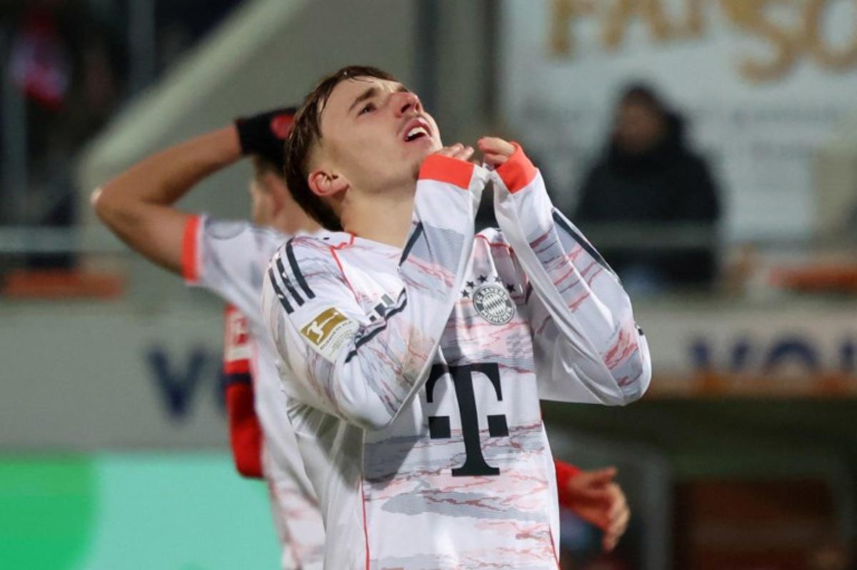 Bayern Munich's German midfielder #42 Lennart Karl reacts during the German first division Bundesliga football match between FC Heidenheim and FC Bayern Munich in Heidenheim, southern Germany, on December 21, 2025. Karl-Josef HILDENBRAND / AFP