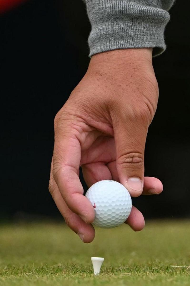 South Africa's Thriston Lawrence places his ball on it's tee on the 11th during his third round, on day three of the 152nd British Open Golf Championship at Royal Troon on the south west coast of Scotland on July 20, 2024. ANDY BUCHANAN / AFP