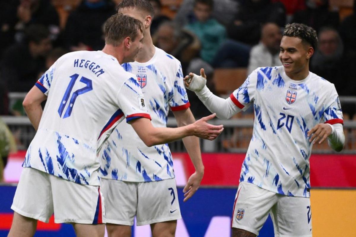 Norway's forward #20 Antonio Nusa celebrates with teammate Norway's defender #17 Torbjorn Lysaker Heggem after scoring his team's first goal during the FIFA World Cup 2026 European qualification football match between Italy and Norway, at the San Siro Stadium, in Milan, on November 16, 2025. Alberto PIZZOLI / AFP