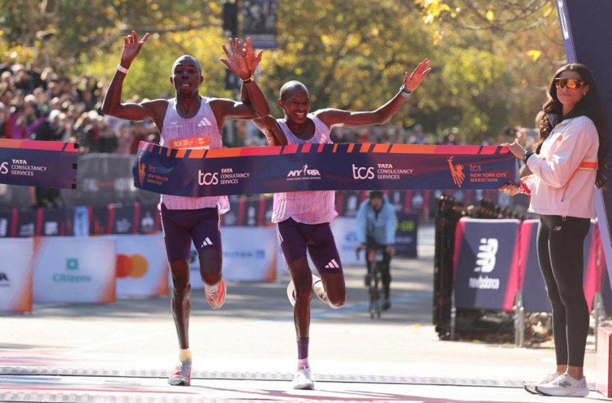 Kenyans Benson Kipruto (L) and Alexander Mutiso celebrate taking first and second place respectively in the New York Marathon in New York on November 2, 2025. CHARLY TRIBALLEAU / AFP