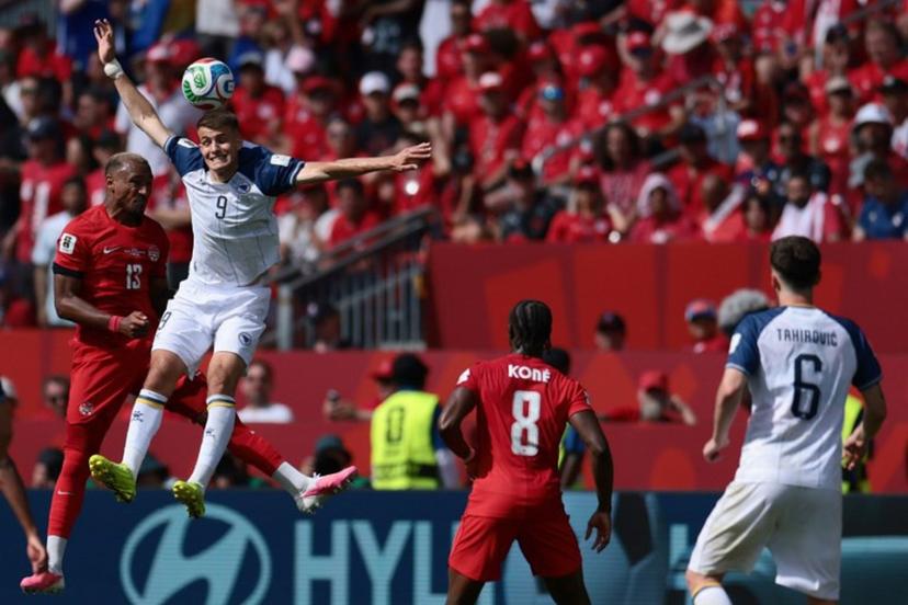Canada's defender #13 Derek Cornelius (L) fights for the ball with Bosnia-Herzegovina's forward #09 Samed Bazdar (2ndL) during the 2026 World Cup Group B football match between Canada and Bosnia and Herzegovina at the Toronto Stadium in Toronto on June 12, 2026. Cole Burston / AFP