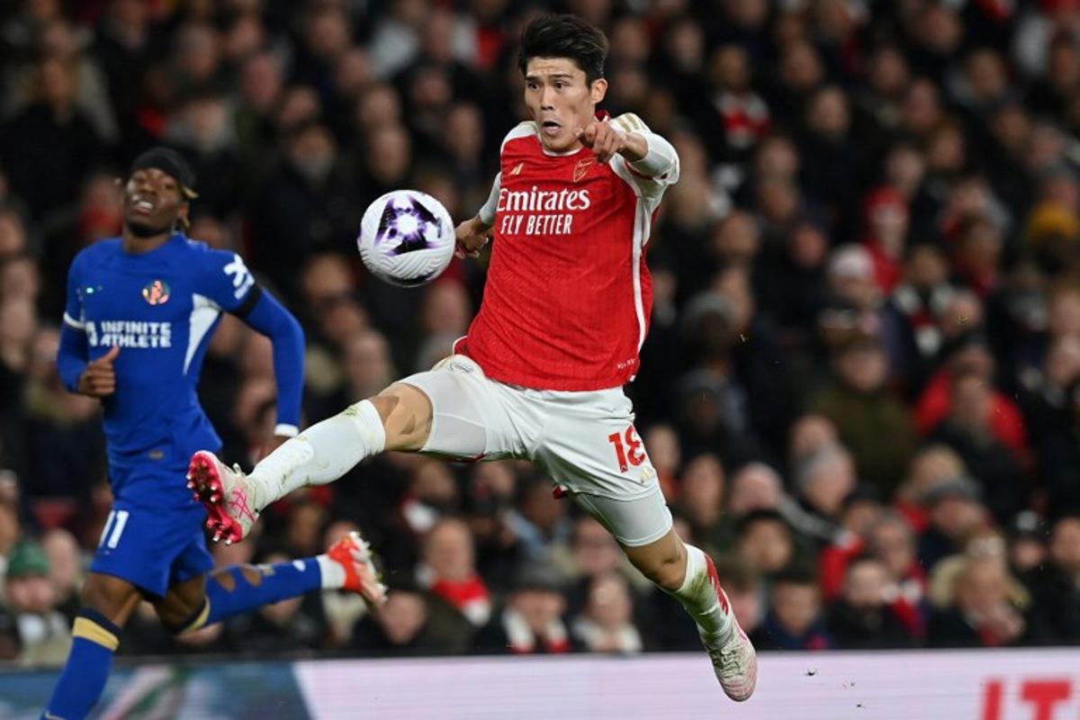Arsenal's Japanese defender #18 Takehiro Tomiyasu controls the ball during the English Premier League football match between Arsenal and Chelsea at the Emirates Stadium in London on April 23, 2024. Glyn KIRK / AFP
