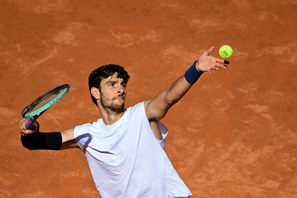Italy's Lorenzo Musetti serves to Spain's Carlos Alcaraz during their men's singles semi-final match for the ATP Rome Open tennis tournament at Foro Italico in Rome on May 16, 2025. Tiziana FABI / AFP