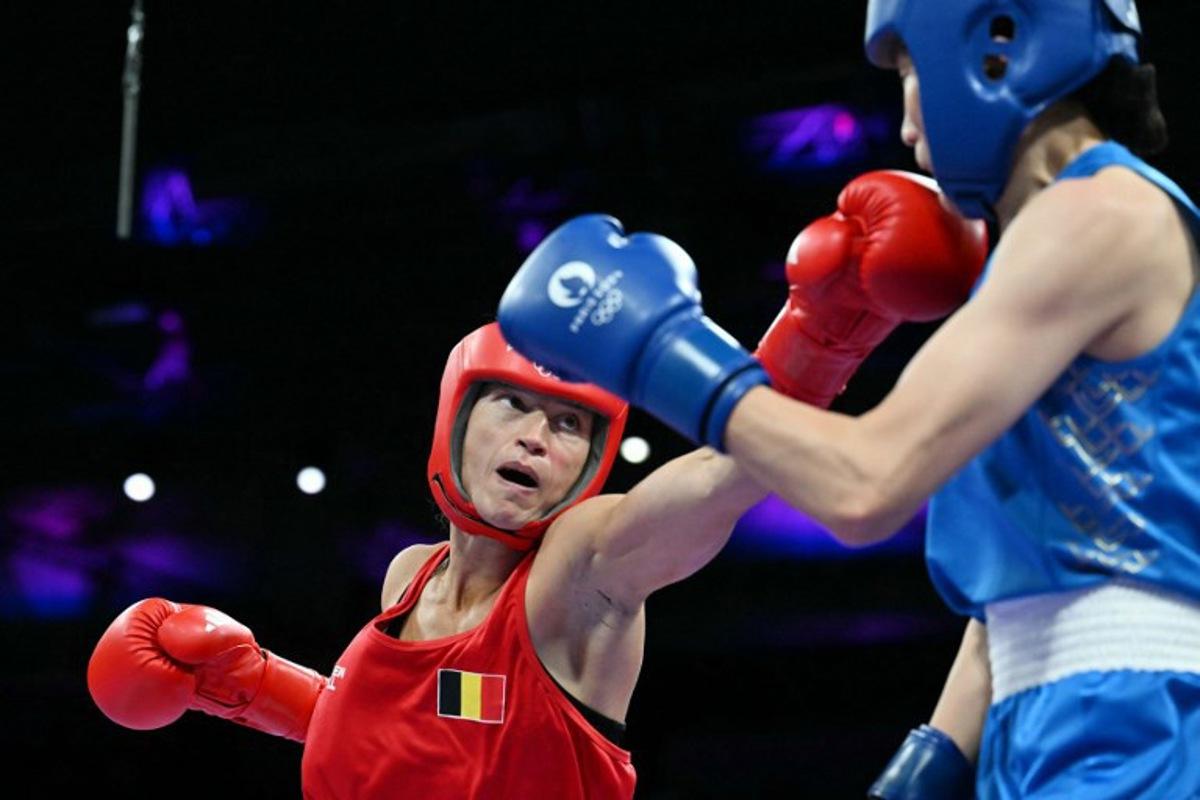 Belgium's Oshin Derieuw (L) fights against China's Yang Liu in the women's 66kg quarter-final boxing match during the Paris 2024 Olympic Games at the North Paris Arena, in Villepinte on August 3, 2024. MOHD RASFAN / AFP