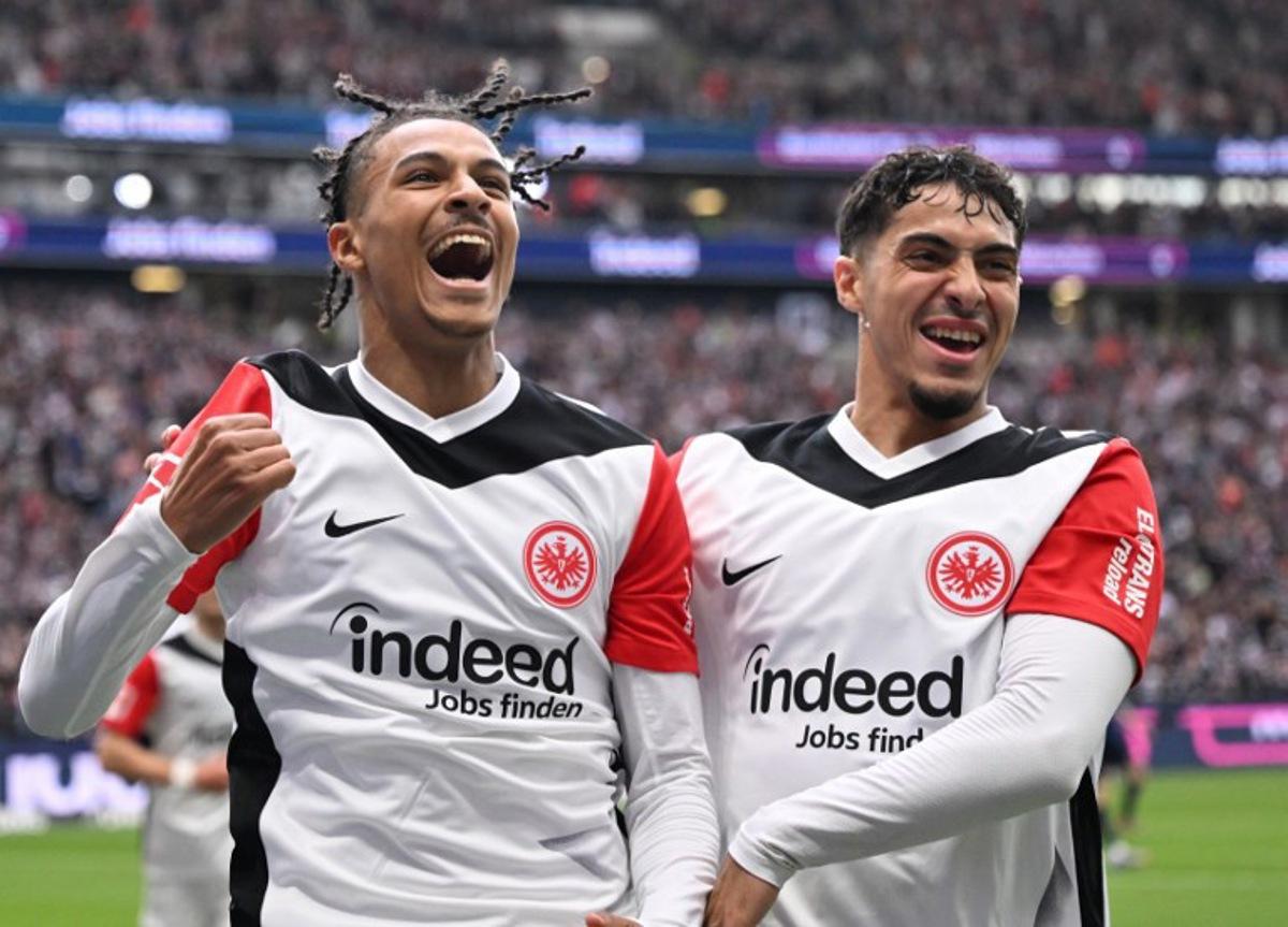 Frankfurt's French forward #19 Jean-Matteo Bahoya (L) celebrates with Frankfurt's Algerian midfielder #08 Fares Chaibi scoring during the German first division Bundesliga football match between Eintracht Frankfurt and Heidenheim in Frankfurt am Main, western Germany, on April 13, 2025. Kirill KUDRYAVTSEV / AFP