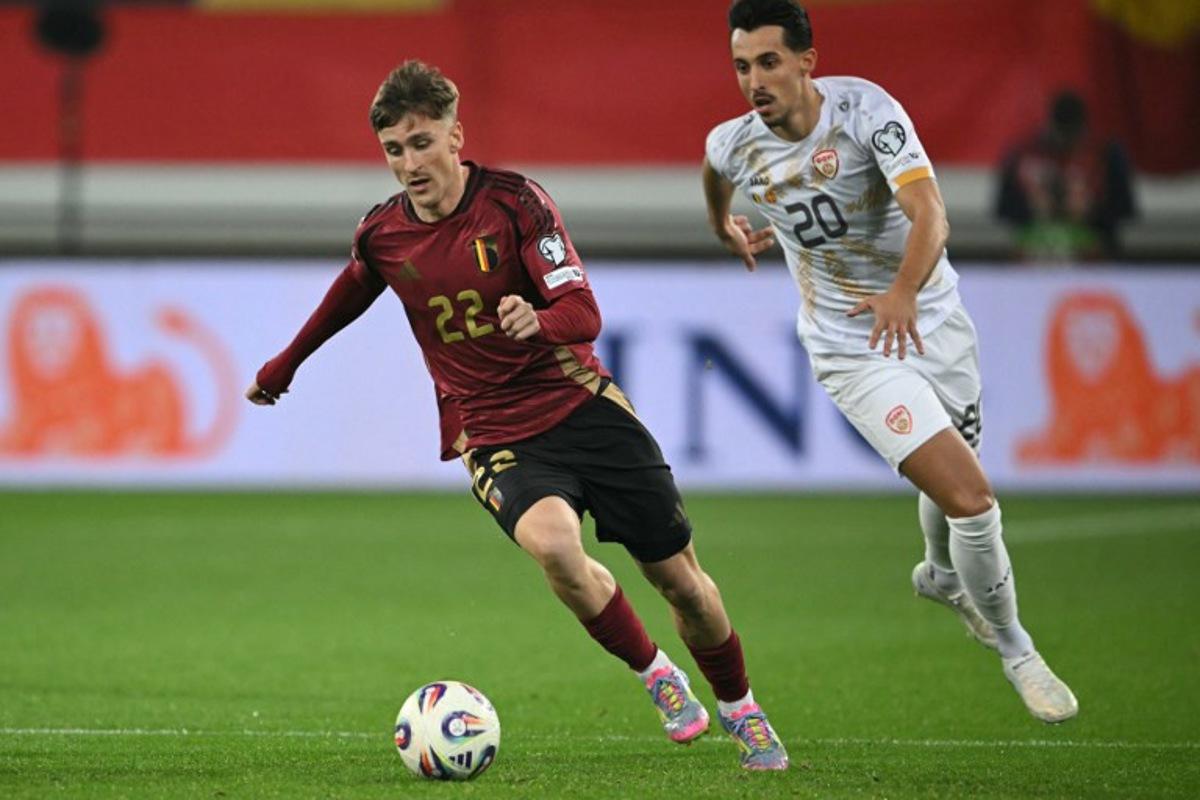 Belgium's midfielder #22 Alexis Saelemaekers (L) fights for the ball with North Macedonia 's forward #20 Bojan Miovski during the FIFA World Cup 2026 Group J European qualification football match between Belgium and North Macedonia at the Planet Group Arena in Ghent, on October 10, 2025. NICOLAS TUCAT / AFP