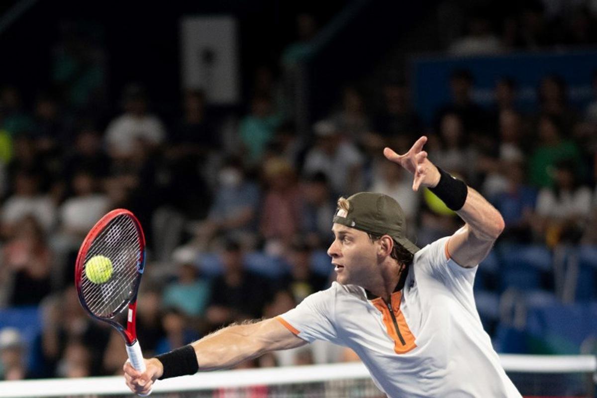 Belgium's Zizou Bergs hits a return against Spain's Carlos Alcaraz during their men's singles match at the ATP Japan Open tennis tournament in Tokyo on September 27, 2025. Philip FONG / AFP