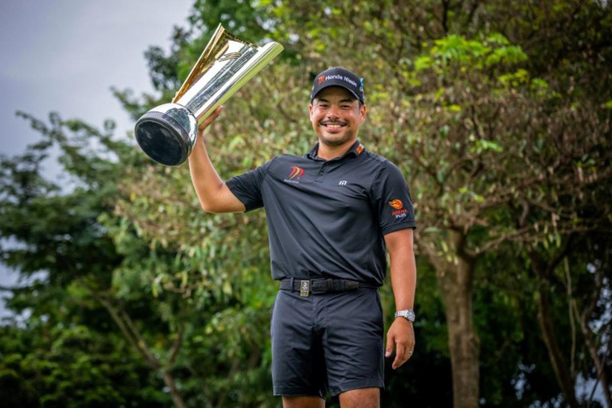 This handout photograph from the Asian Tour taken and received on October 26, 2025 shows Philippines' Miguel Tabuena posing with the trophy during the presentation ceremony, after winning the International Series Philippines golf tournament at Sta. Elena Golf Club in Santa Rosa, Laguna province. Graham Uden / Asian Tour / AFP