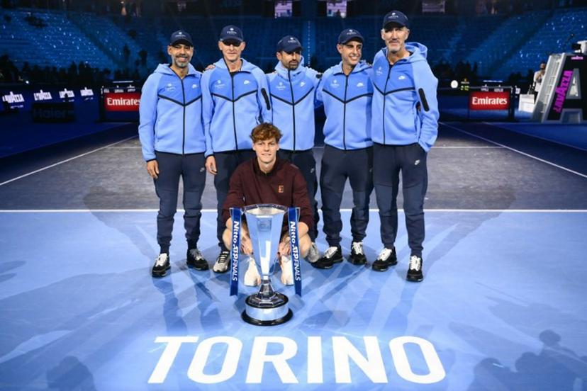 Italy's Jannik Sinner and members of this team pose with the trophy at the end of the men's single final match at the ATP Finals tennis tournament, in Turin, on November 16, 2025. Marco BERTORELLO / AFP