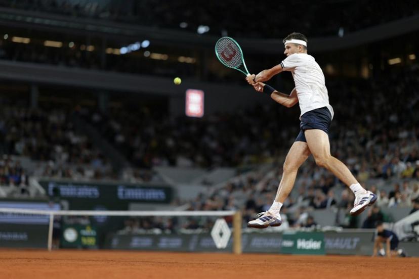 Czech Republic's Jakub Mensik plays a backhand return to Brazil's Joao Fonseca during their men's quarter final singles match on day 10 of the French Open tennis tournament on Court Philippe-Chatrier at the Roland-Garros Complex in Paris on June 2, 2026. Thomas SAMSON / AFP